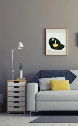 Customized white sofa with wall decor, night lamp, and side stand designed by Home Interior Services