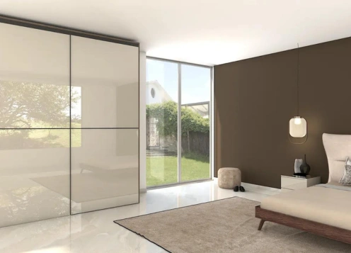 A Modern bedroom with large windows, minimalistic furniture, and a view of greenery outside.