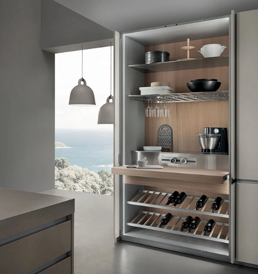 A modern kitchen featuring an cabinet neatly displaying utensils, with windows offering a scenic view.