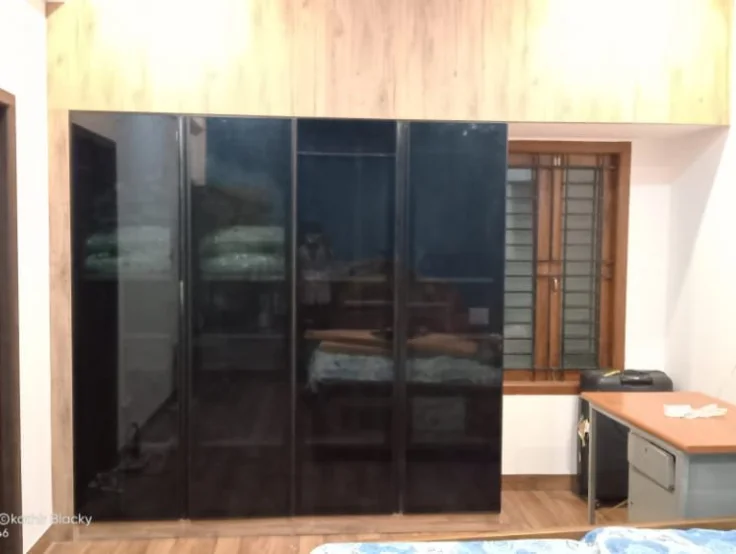 A wardrobe and a simple desk, with their clean lines and functionality, showcase a modern bedroom.
