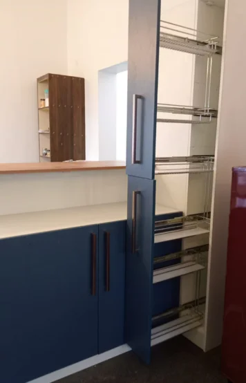 A contemporary refrigerator and cabinets create a stylish atmosphere in this industrial loft kitchen