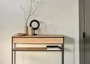 A small table featuring a shelf below and a decorative vase placed on top, showcasing a minimalist design.