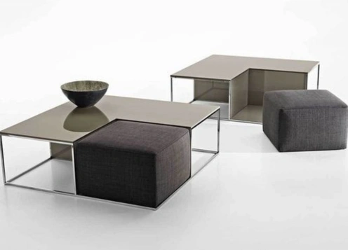 Two coffee tables accompanied by a sleek black ottoman, showcasing a modern and stylish living space.