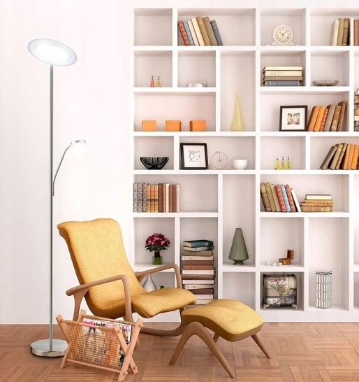 A stylish chair and lamp in front of a wall-mounted bookshelf illustrate the comfort of the space.