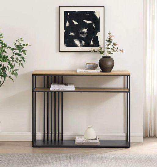A Modern console table with decor against a wall, under a black and white abstract painting.