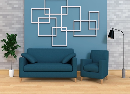 A couch & chair positioned in front of a wall adorned with white square patterns, modern aesthetic.